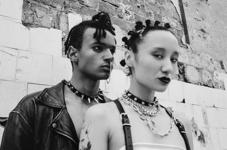Black and white photo capturing the essence of punk fashion with striking spiked accessories.